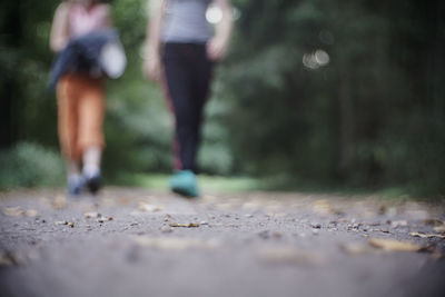 Low section of people walking on footpath