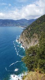 Scenic view of sea and mountains against sky