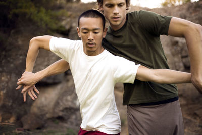 Male performers practicing dance outdoors