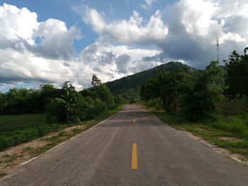 Road amidst trees against sky