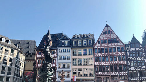 Low angle view of buildings against blue sky