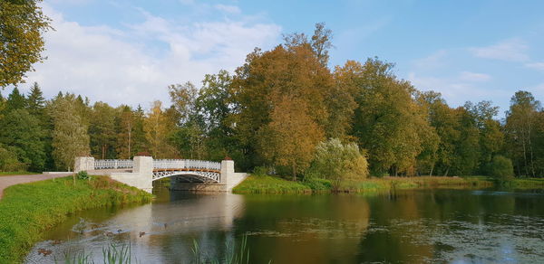 Arch bridge over river against sky