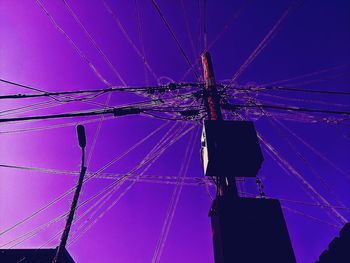 Low angle view of electricity pylon against sky
