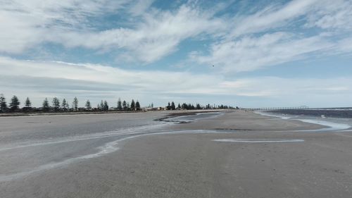 Scenic view of beach against sky in city