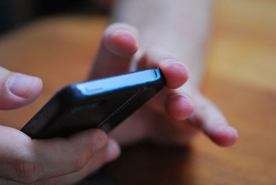 Close-up of hand holding smart phone