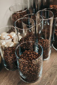 Close-up of coffee beans in glass on table