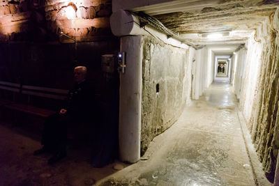 Man standing in corridor of building