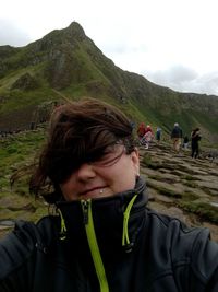 Close-up portrait of smiling woman at giants causeway