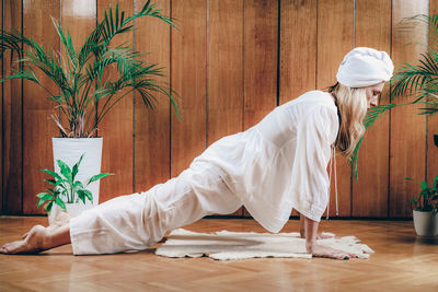 Woman practicing kundalini kriya yoga for feminine energy and instincual self.