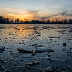 Scenic view of lake against sky during sunset