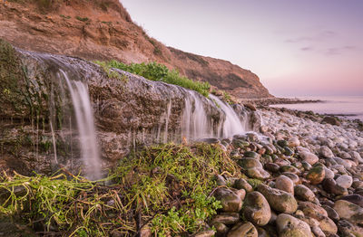 Scenic view of waterfall against clear sky