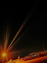 Low angle view of illuminated buildings against sky at night