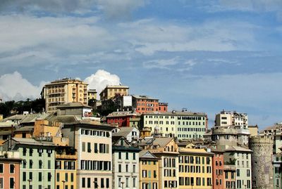 Buildings against cloudy sky