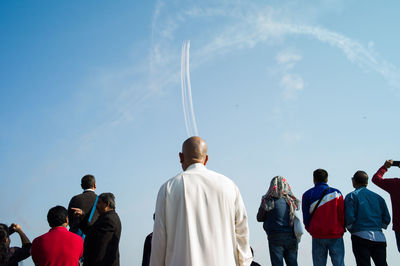 Man standing against cloudy sky