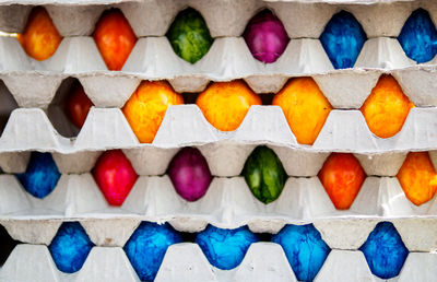 Full frame shot of cartons with colorful easter eggs