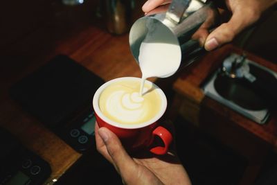 Midsection of woman holding coffee cup