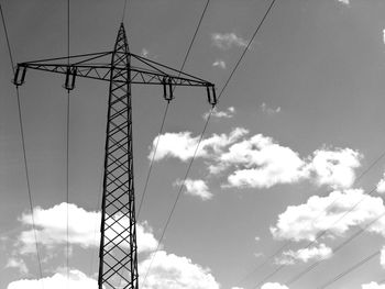 Low angle view of electricity pylon against sky