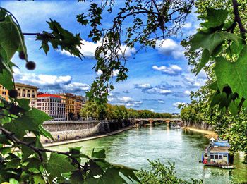 View of canal against cloudy sky