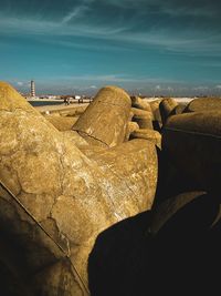 Panoramic view of rocks on beach against sky