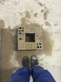 Low section of woman standing on tiled floor