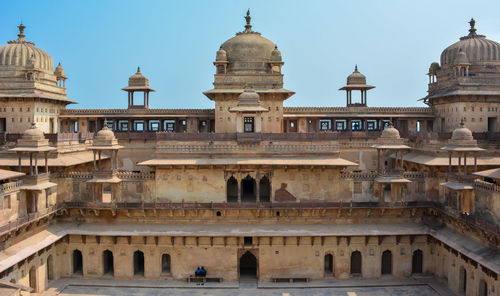 View of buildings in city against clear sky