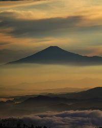 Scenic view of silhouette mountains against sky during sunset