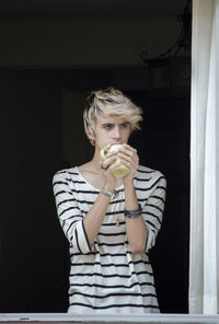 Full length of senior woman eating food