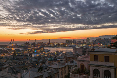 High angle view of buildings in city during sunset