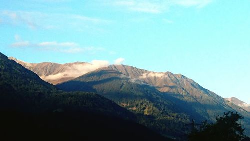 Low angle view of mountains against blue sky