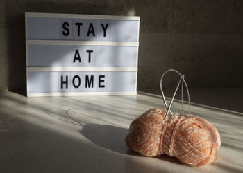 Close-up of text on table against wall