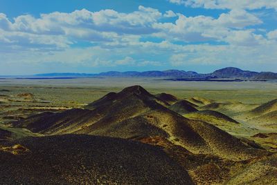 Scenic view of landscape against cloudy sky