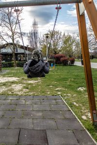 Statue in park against sky