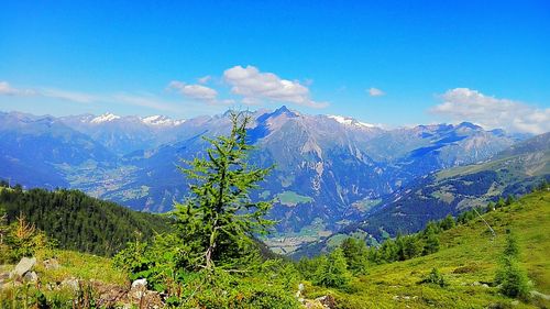 Scenic view of snowcapped mountains against blue sky