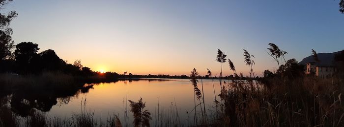 Scenic view of lake against sky during sunset