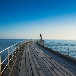 Pier over sea against clear blue sky whitby