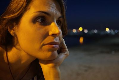 Close-up portrait of young woman looking away