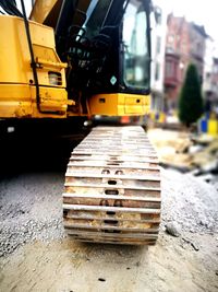 Close-up of yellow construction site on road in city