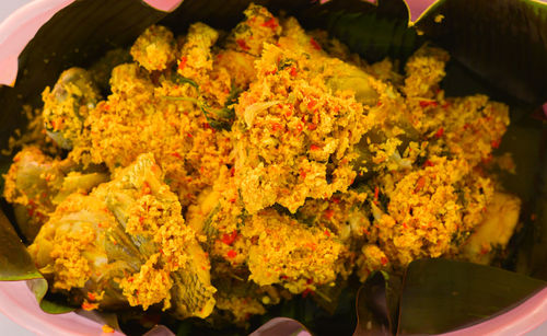 High angle view of orange rose in plate