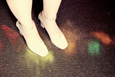 Low section of man standing on tiled floor