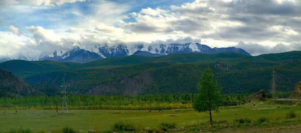 Scenic view of mountains against cloudy sky