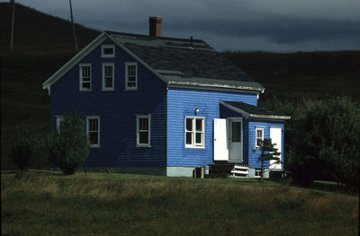 House on field against sky at night