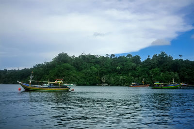 Boat in river against sky