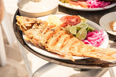 High angle view of fried fish served in plate on table
