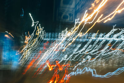 Low angle view of firework display at night