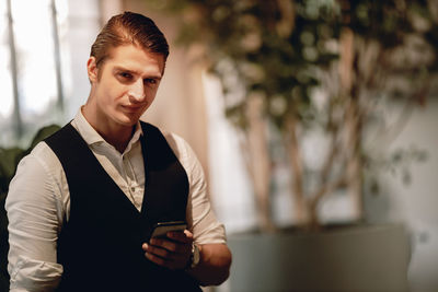 Portrait of young man using smart phone outdoors