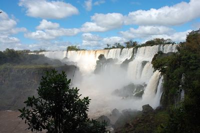 Scenic view of waterfall against sky