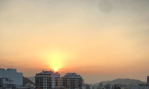 Buildings against sky during sunset