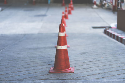 Row of red traffic cones on road