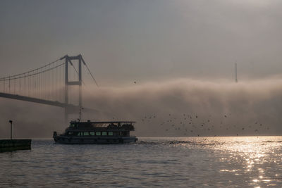 Boat and 15 july martyrs in foggy morning istanbul turkey 