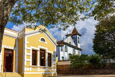 Facade of old colonial style house and baroque church in the town of diamantina in minas gerais